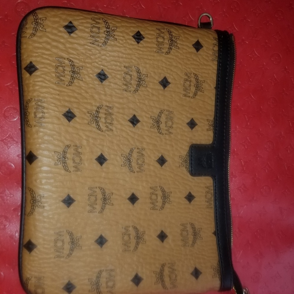 MCM cluth w a wrist strap.